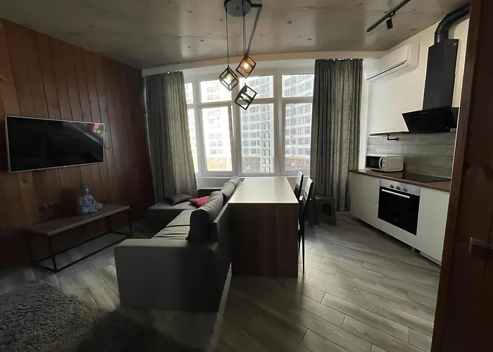 стильный лофт в аркадии - спальня и кухня-студия с боковым видом на море Апартаменты